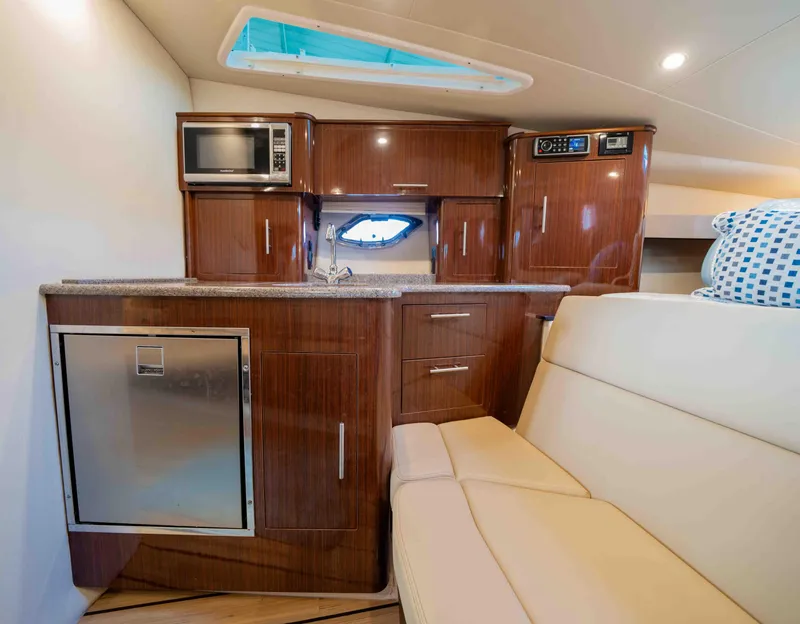 Slide: The Image of Interior of 2015 Regal 35 Sport Coupe with kitchenette and seating area. - 28