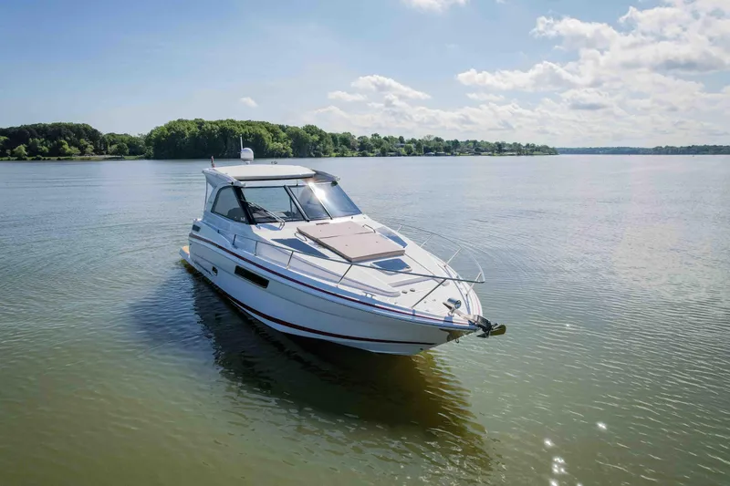 Slide: The Image of 2015 Regal 35 Sport Coupe on serene lake under blue sky. - 3