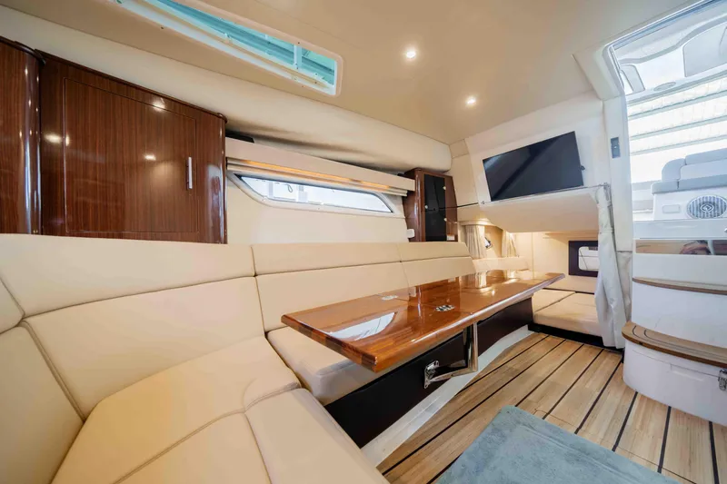 Slide: The Image of Luxurious interior of 2015 Regal 35 Sport Coupe yacht with elegant seating and wooden accents. - 30
