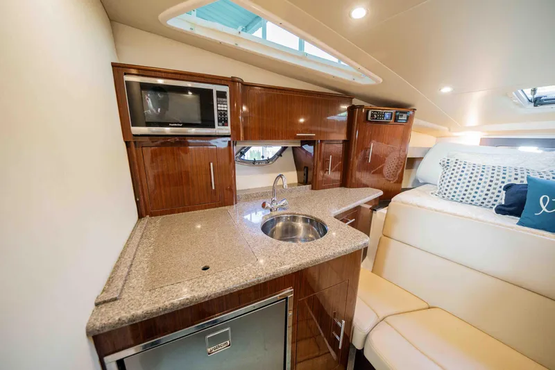 Slide: The Image of Luxurious interior of 2015 Regal 35 Sport Coupe with kitchenette and seating area. - 32