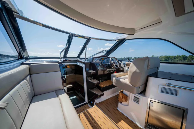 Slide: The Image of 2015 Regal 35 Sport Coupe interior with modern helm, seating, and panoramic windows. - 43