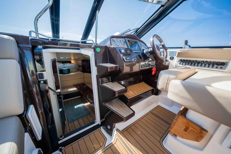 Slide: The Image of Interior of 2015 Regal 35 Sport Coupe, featuring helm and cabin entrance. - 44