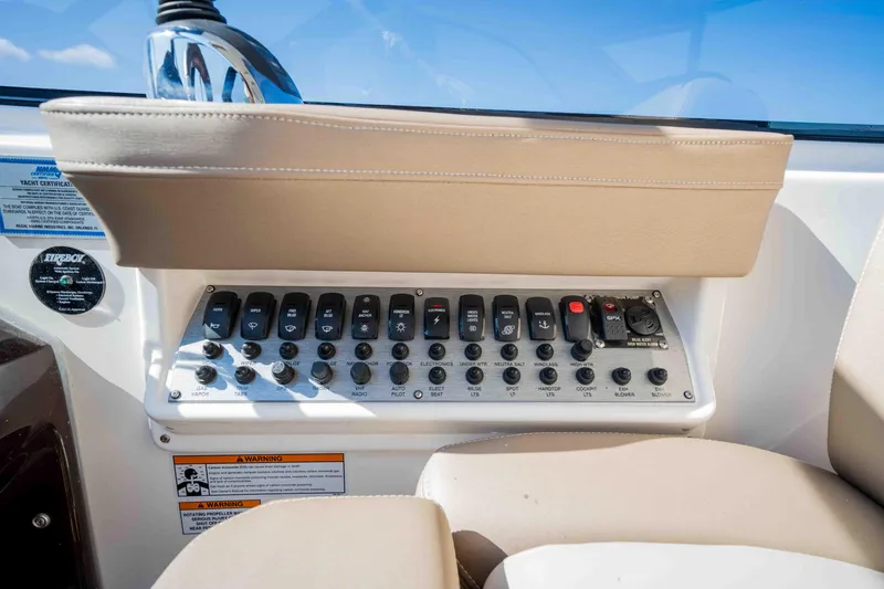 Slide: The Image of Control panel of a 2015 Regal 35 Sport Coupe boat with beige seating. - 45