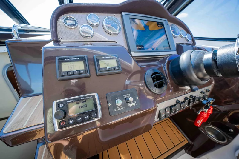Slide: The Image of Control panel of a 2015 Regal 35 Sport Coupe boat with navigation instruments. - 46