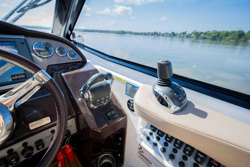 Slide: The Image of Cockpit view of 2015 Regal 35 Sport Coupe with steering wheel and control panel. - 48