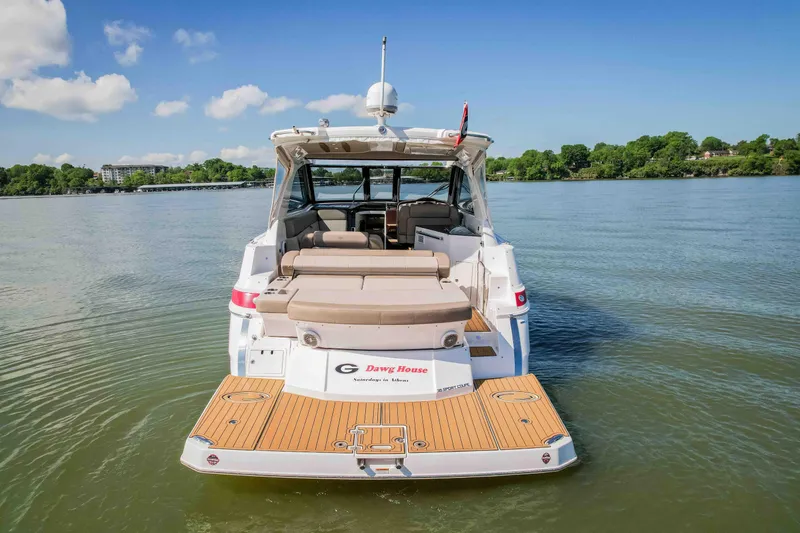 Slide: The Image of 2015 Regal 35 Sport Coupe on calm lake, rear view with open deck. - 6