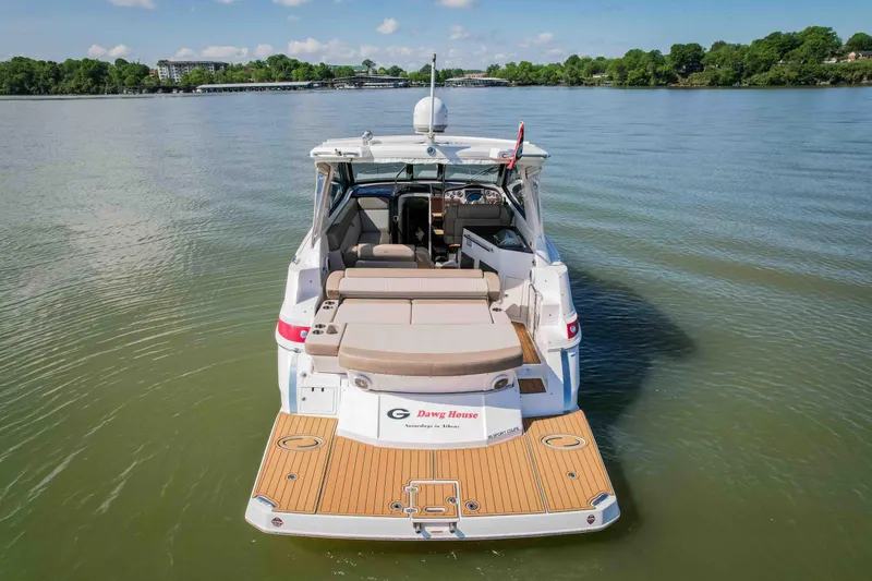 Slide: The Image of 2015 Regal 35 Sport Coupe boat on calm water, rear view with open cockpit. - 7