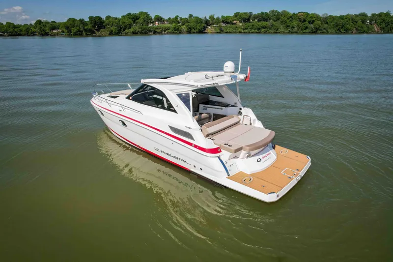 Slide: The Image of 2015 Regal 35 Sport Coupe boat on calm lake waters. - 9