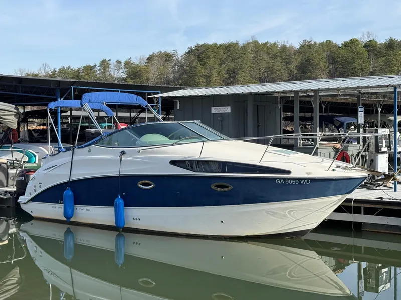 The Image of 2008 Bayliner 265SB boat docked at marina with blue canopy and fenders. - 0