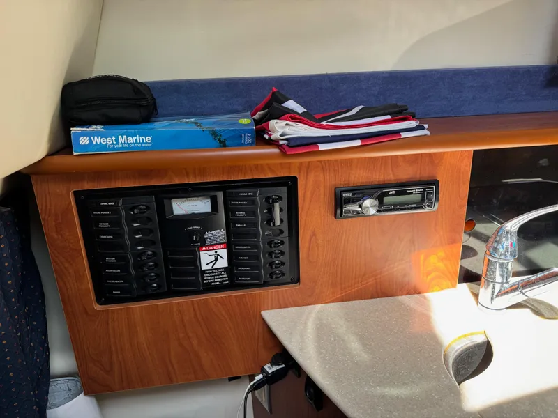 Slide: The Image of 2008 Bayliner 265SB cabin interior with control panel, stereo, and countertop. - 12