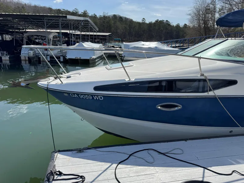 Slide: The Image of 2008 Bayliner 265SB boat docked at marina, blue and white hull, registration GA 9059 WD. - 3
