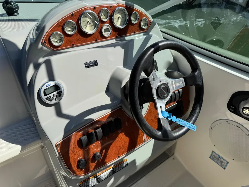 Slide: The Image of 2008 Bayliner 265SB boat dashboard with steering wheel and instrument panel. - 8