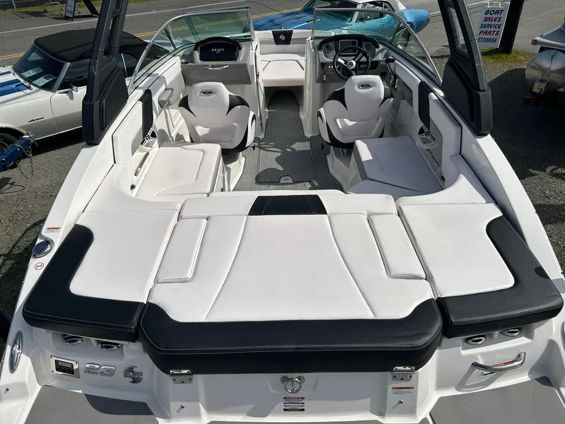 Slide: The Image of 2019 Chaparral 23 H2O Surf boat interior with white seating and modern dashboard. - 11
