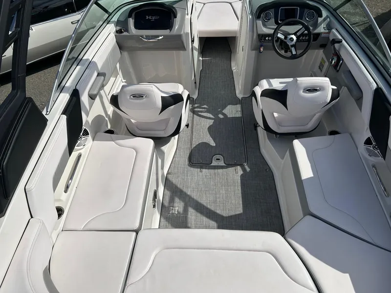 Slide: The Image of 2019 Chaparral 23 H2O Surf boat interior with white seating and modern dashboard. - 12