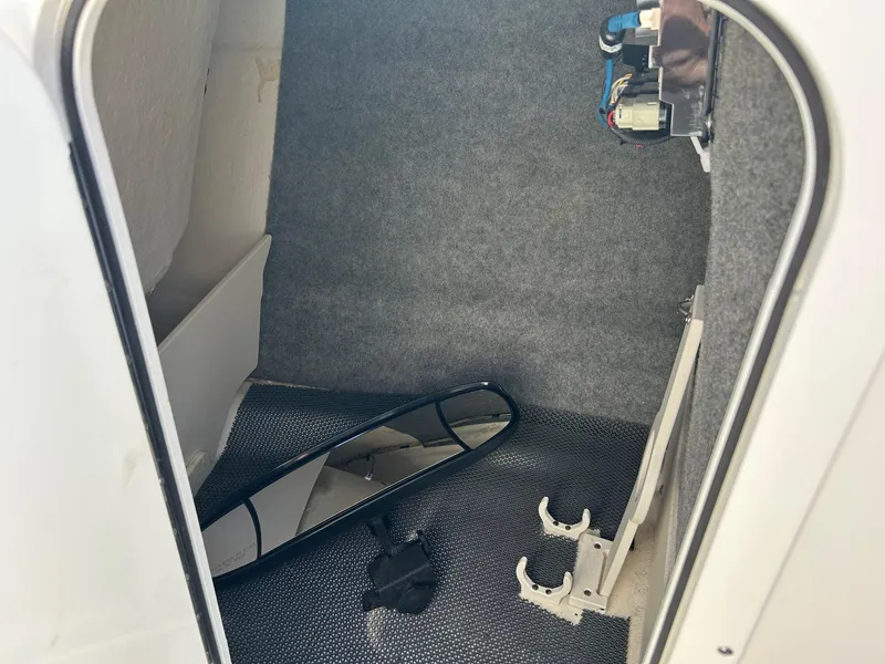 Slide: The Image of Interior storage compartment of 2019 Chaparral 23 H2O Surf boat with accessories. - 20