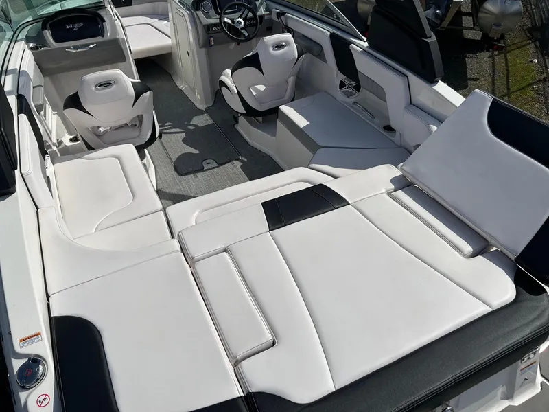 Slide: The Image of 2019 Chaparral 23 H2O Surf boat interior with white and black seating. - 21