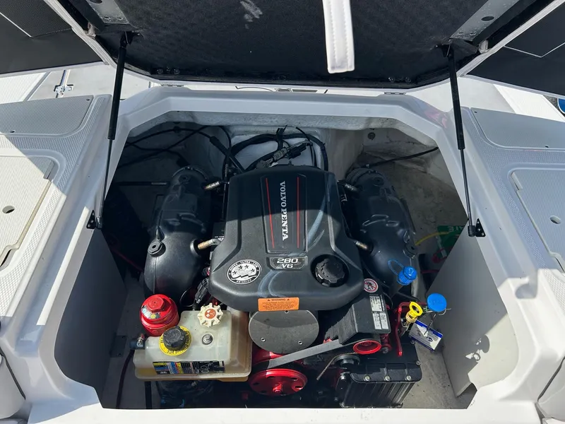 Slide: The Image of Engine compartment of a 2019 Chaparral 23 H2O Surf boat, featuring a Volvo Penta engine. - 23