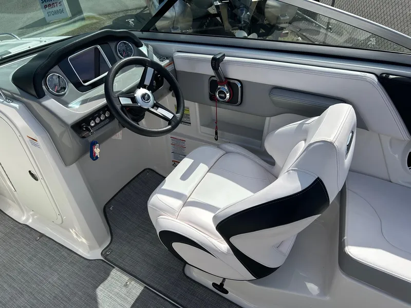 Slide: The Image of 2019 Chaparral 23 H2O Surf boat interior with steering wheel and captain's chair. - 5