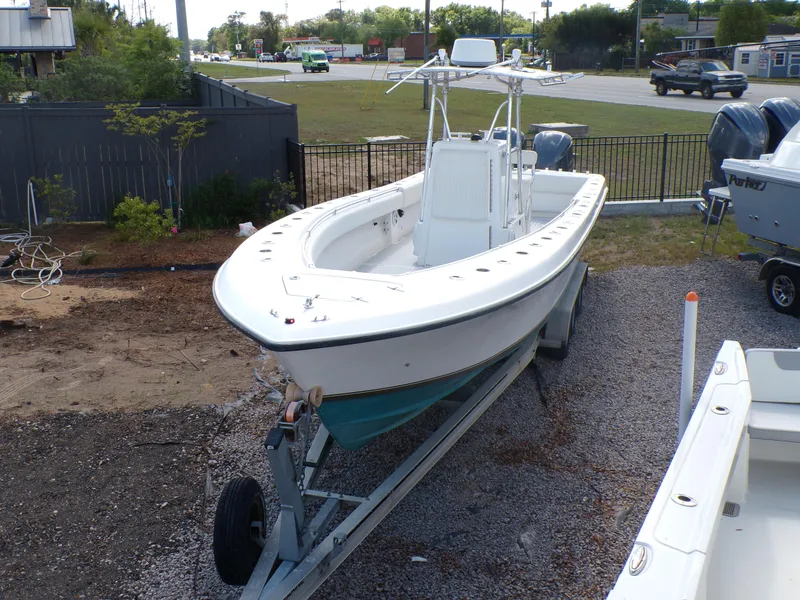 Slide: The Image of 2002 Contender 31 Center Console boat on trailer, parked outdoors. - 1