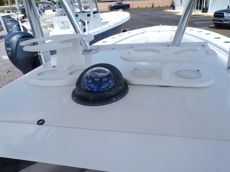 Slide: The Image of 2002 Contender 31 Center Console boat dashboard with compass and cup holders. - 10