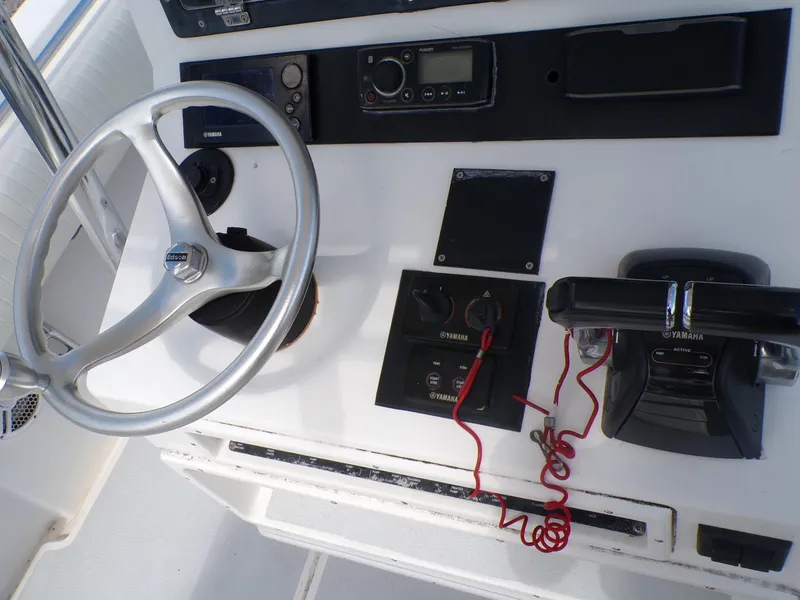 Slide: The Image of 2002 Contender 31 Center Console helm with steering wheel and Yamaha controls. - 11