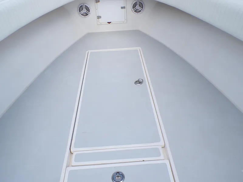 Slide: The Image of 2002 Contender 31 Center Console boat interior with storage compartments and speakers. - 18