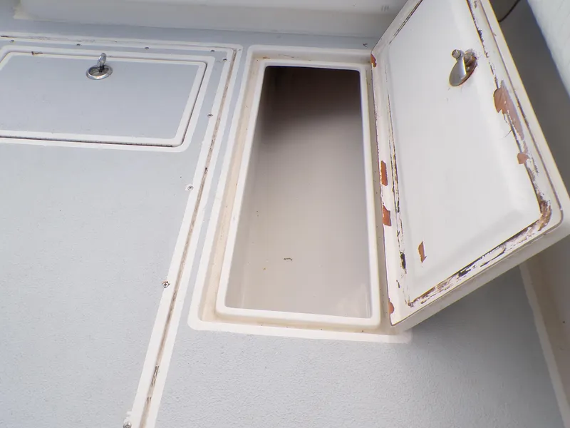 Slide: The Image of Open storage compartment on a 2002 Contender 31 Center Console boat. - 21