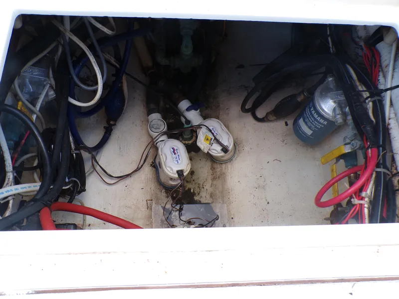 Slide: The Image of Bilge area of a 2002 Contender 31 Center Console with wiring and pumps visible. - 22