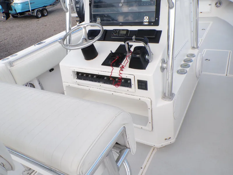 Slide: The Image of 2002 Contender 31 Center Console boat interior with steering wheel and control panel. - 24