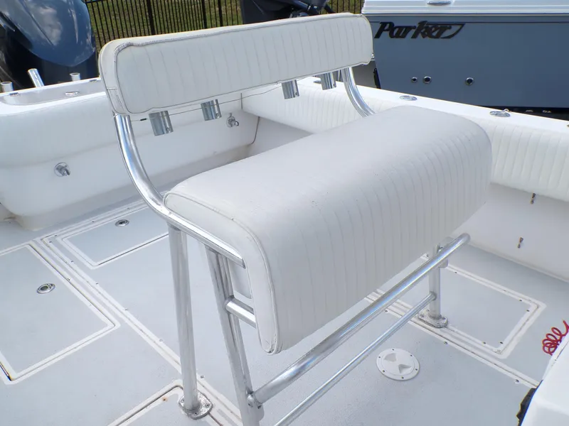Slide: The Image of 2002 Contender 31 Center Console boat with white cushioned seating and stainless steel frame. - 25
