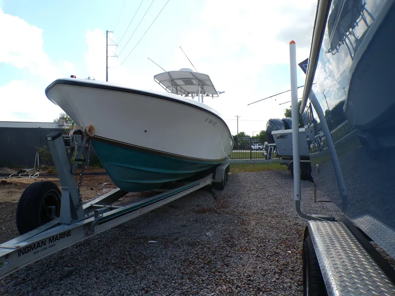 Slide: The Image of 2002 Contender 31 Center Console boat on trailer, parked on gravel. - 3
