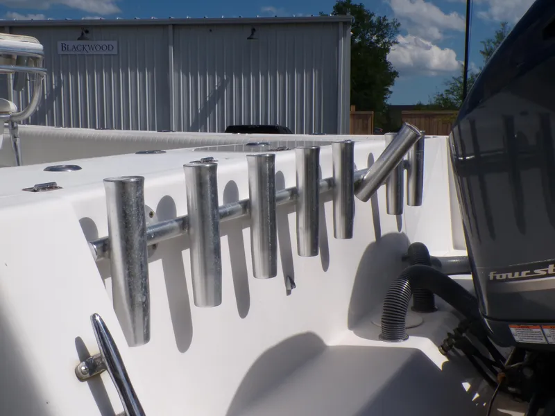 Slide: The Image of 2002 Contender 31 Center Console boat with rod holders and four-stroke engine. - 6