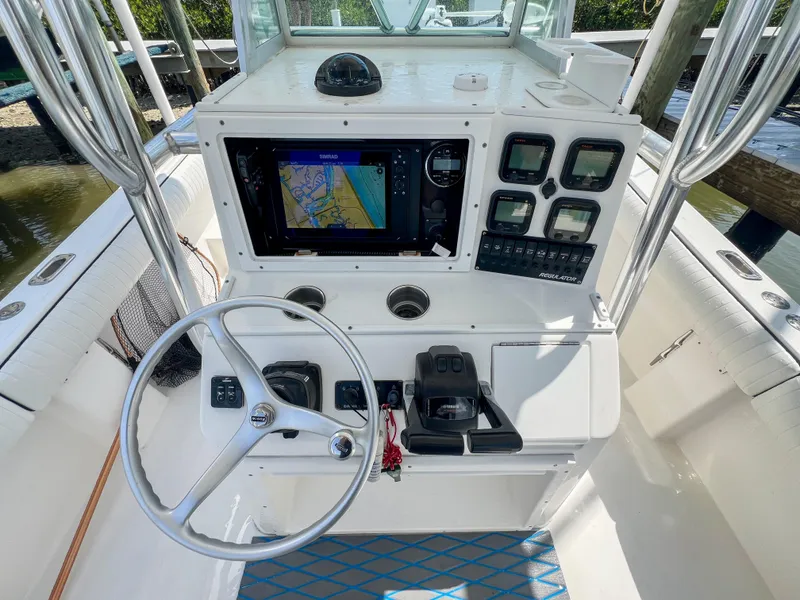 Slide: The Image of 2006 Regulator 26 FS boat console with steering wheel, navigation system, and control panel. - 11