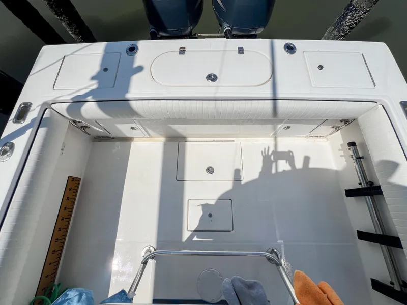 Slide: The Image of 2006 Regulator 26 FS boat deck with storage compartments and fishing equipment. - 17