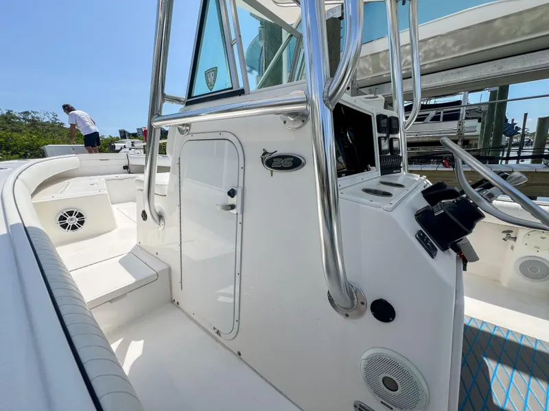 Slide: The Image of 2006 Regulator 26 FS boat interior with steering console and seating area. - 18