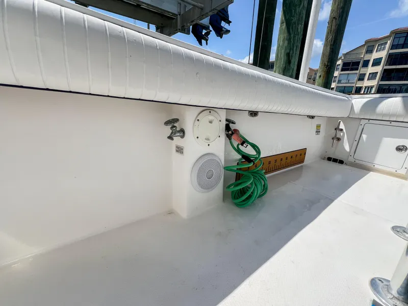 Slide: The Image of 2006 Regulator 26 FS boat deck with hose, speaker, and storage compartments. - 20