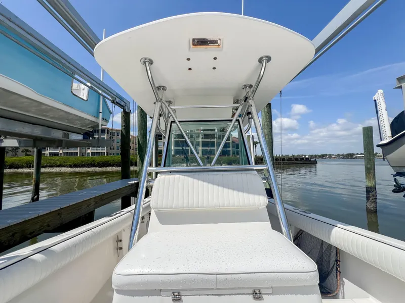 Slide: The Image of 2006 Regulator 26 FS boat with T-top, docked on a sunny day. - 23