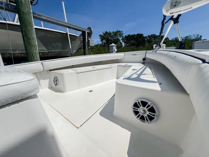 Slide: The Image of 2006 Regulator 26 FS boat interior with seating and speakers, under clear blue sky. - 24