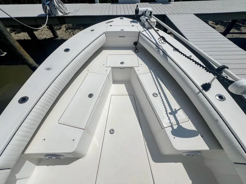 Slide: The Image of 2006 Regulator 26 FS boat deck with seating and storage compartments. - 25