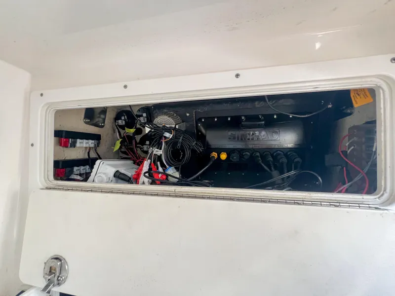 Slide: The Image of 2006 Regulator 26 FS engine compartment with wiring and components visible. - 27