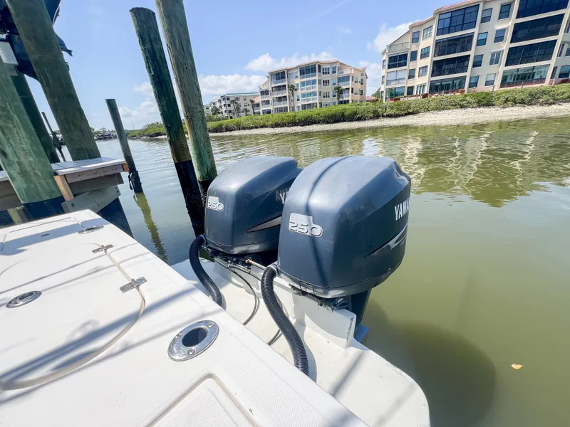Slide: The Image of Twin Yamaha outboard engines on a 2006 Regulator 26 FS boat docked by waterfront buildings. - 29