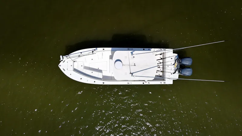 Slide: The Image of Aerial view of 2006 Regulator 26 FS boat on water, featuring dual engines. - 6