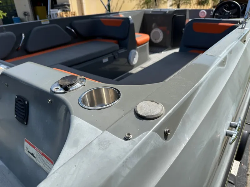 Slide: The Image of 2019 Bayliner Element E21 boat interior with seating and cup holders. - 4