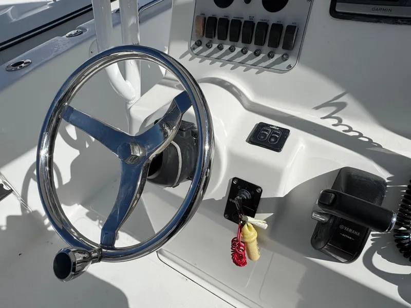 Slide: The Image of Steering wheel and controls of a 2011 Tidewater 230 boat. - 11