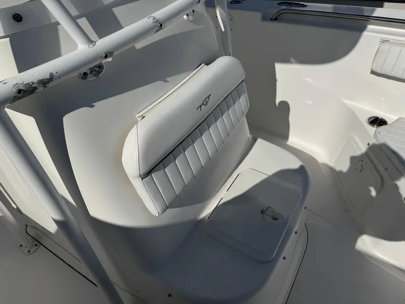 Slide: The Image of White seating area on a 2011 Tidewater 230 boat, featuring cushioned backrest. - 15