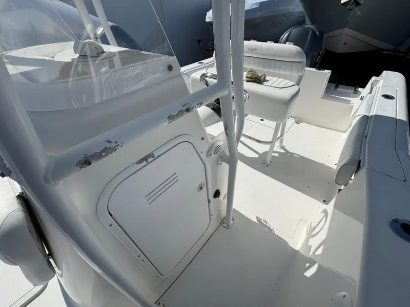 Slide: The Image of 2011 Tidewater 230 boat interior with white seating and console. - 19