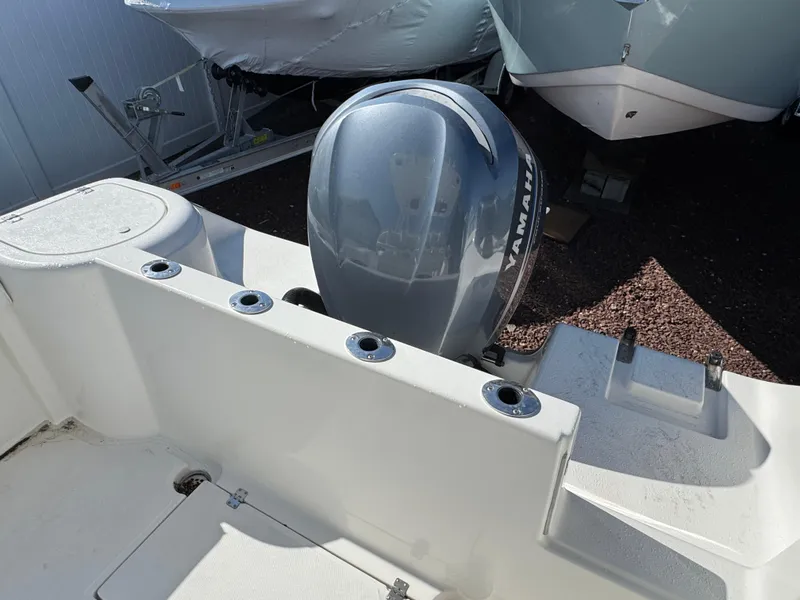 Slide: The Image of Tidewater 230 boat, 2011 model, featuring a Yamaha outboard motor, docked on gravel. - 5