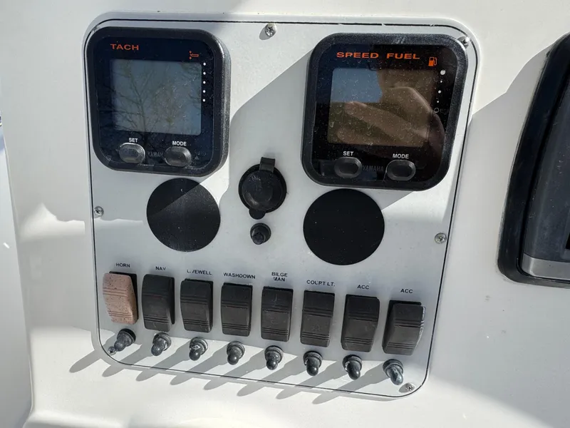 Slide: The Image of Control panel of a 2011 Tidewater 230 boat with tachometer and speed fuel gauges. - 9