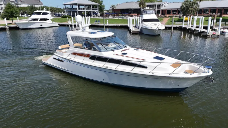 The Image of 2007 Chris-Craft Roamer 40 yacht cruising in a marina, surrounded by other boats. - 0