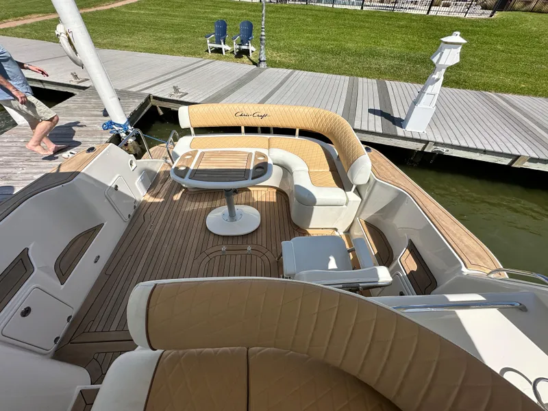 Slide: The Image of 2007 Chris-Craft Roamer 40 yacht with elegant deck seating and wooden table. - 17